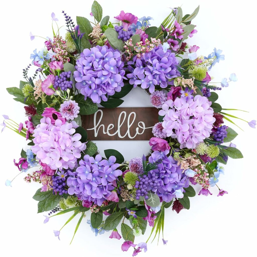 Large hydrangea and wildflower wreath with eucalyptus leaves and “Hello” sign hanging on a front door
